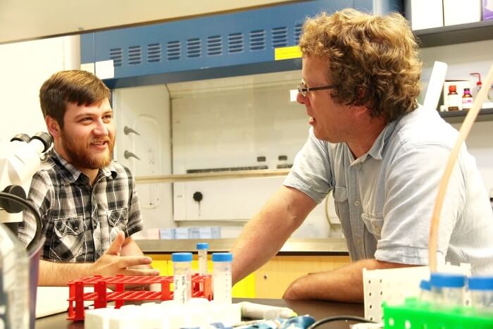 Paul Mayne // Western News Schulich School of Medicine & Dentistry professor Andrew Leask, right, chats with graduate student James Hutchenreuther regarding their work on identifying the specific actions of certain proteins when dealing with metastatic melanoma. Source: Western News